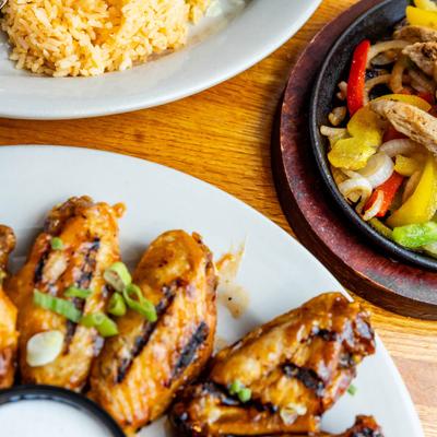 Chicken wings served with rice and chicken fajitas.