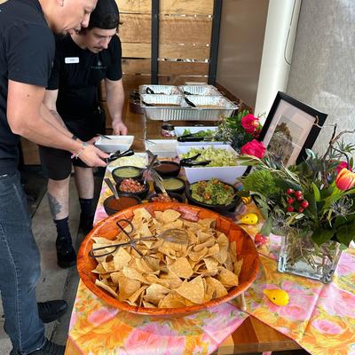 Interior, people serving themselves to food on a buffet table.