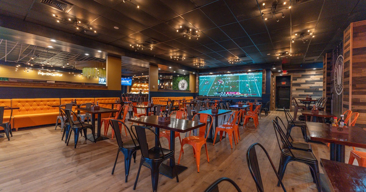Interior, seating area with tables and chairs, TV on the wall