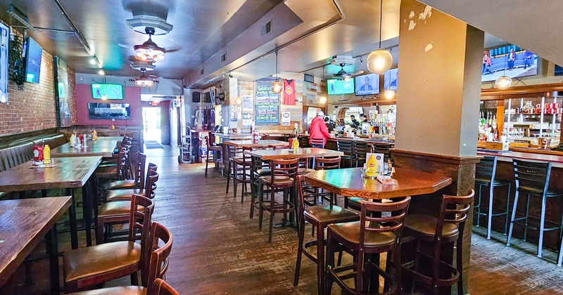Interior, tables and chairs ready for guests, bar on the right side