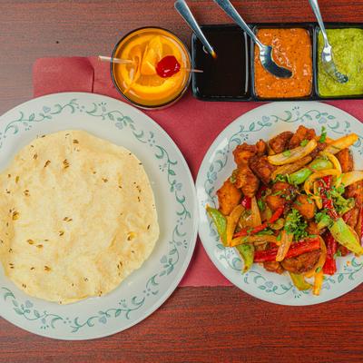 Chicken Manchurian, naan, chutneys, and a glass of Old Fashioned.