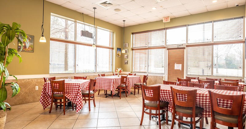 Interior, dining tables with tableware ready for guests