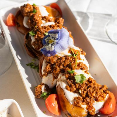 Crispy eggplant, topped with house made yogurt, and meat sauce.