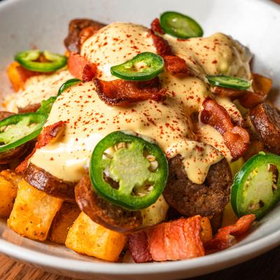 Hash browns topped with sausage, bacon, melted cheese, and jalapenos.