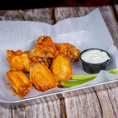 Chicken wings served with celery and dipping sauce.