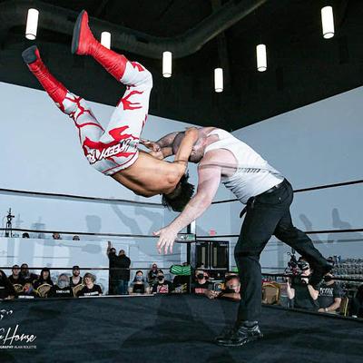 Wrestlers performing  in the ring.