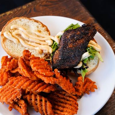 Cajun Mahi Sandwich served with waffle fries.