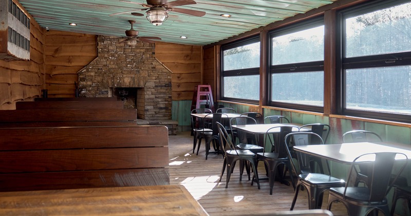 Interior, dining area, wooden seating booths with tables, tables for four and five