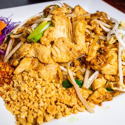 Rice noodles with bean sprouts, onions, egg, and peanuts in Pad Thai Sauce