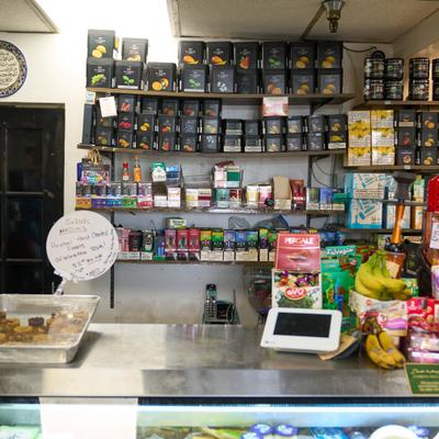 Shelf stocked with teas and various items.