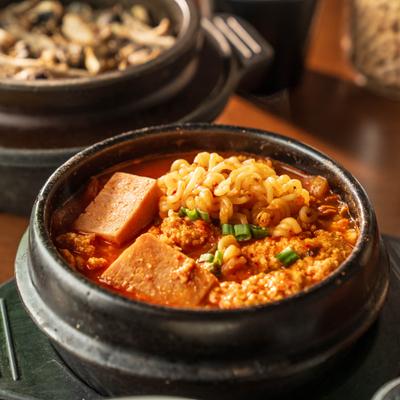 Soft Tofu Stew with rice, noodles, vegetables and herbs.