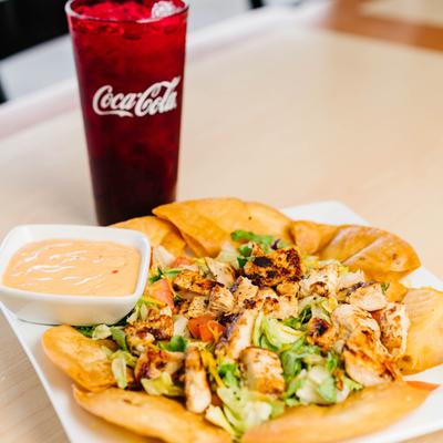 Fiesta Chicken Salad with creamy dressing and a glass of soda.