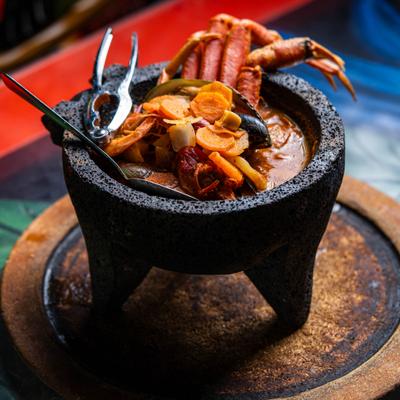 Seafood molcajete filled with crab legs, shrimp, and mussels.