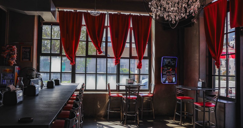 Interior, a bar on the left, tables with chairs on the right
