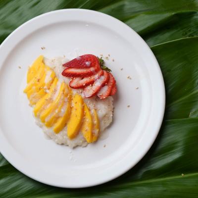 Mango Sticky Rice garnished with sliced strawberry.