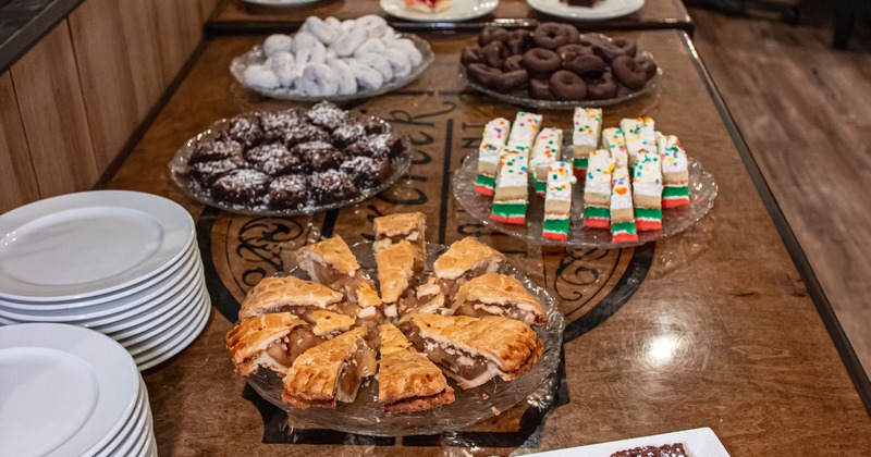 A dessert buffet spread with assorted cakes, brownies, and pastries