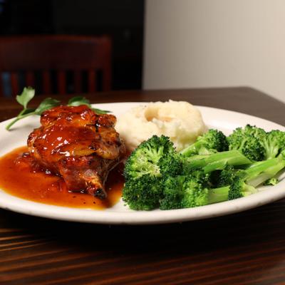 Pork Chop with apricot glaze  with mashed potatoes and broccoli.