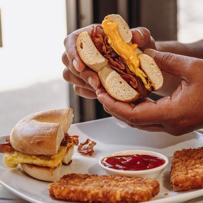 Hands holding a sandwich.