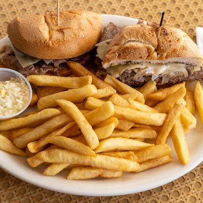 Roast beef sandwich with melted cheese, served with fries and coleslaw.