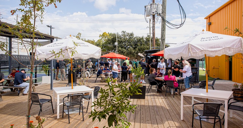 Outdoor seating area with guests sitting at tables