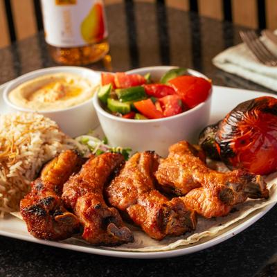 Pork ribs, with rice, hummus, and salad.