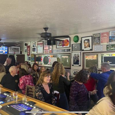 Interior, crowd of people in bar area.