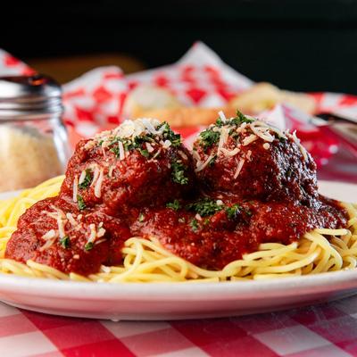 Spaghetti and meatballs covered with meat sauce.