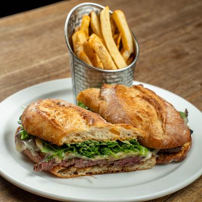The Prime, grilled skirt steak sandwich, served with French fries.
