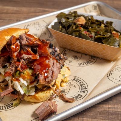 Tipsy Pig, a pulled brisket & pulled pork sandwich served with Southern collard greens.