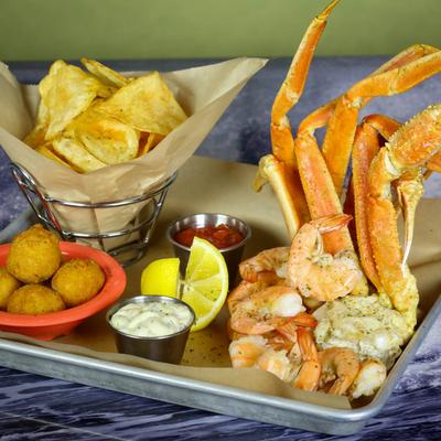 Shrimp and crab leg combo, served with chips, condiments and a ball fritter side.