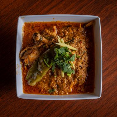 Chicken Karahi, with tomato based butter cream sauce, serrano peppers, herbs, and spices.