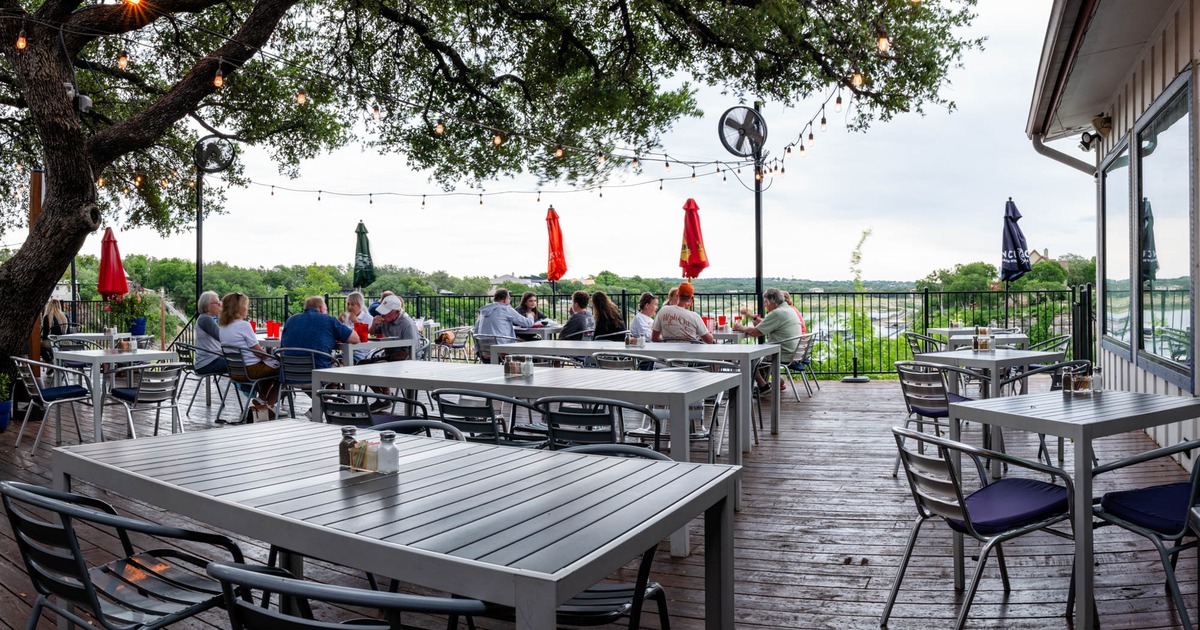 Exterior, tables and chairs lined up, guests sitting and chatting