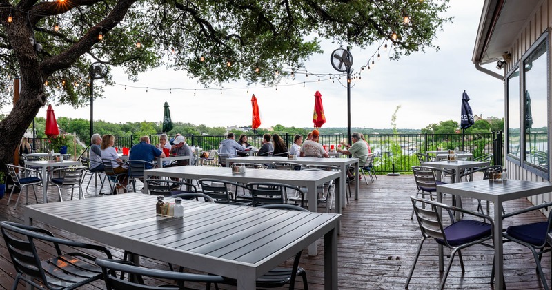 Exterior, tables and chairs lined up, guests sitting and chatting