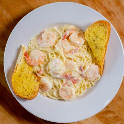 Shrimp Alfredo Spaghetti with toasted bread on the side.