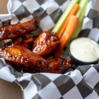 Tavern Wings, celery and carrots, and a sauce dip.