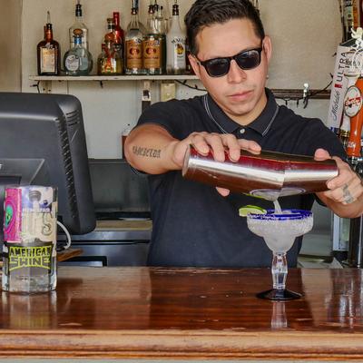 Bartender pouring a cocktail.