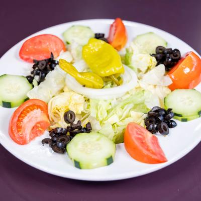 Tossed Salad with lettuce, tomatoes, cucumber, black olives, pepperoncini and onions.
