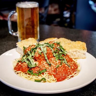 Spaghetti With Marinara and a beer mug next to it