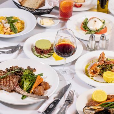 A table set with assortment of dishes and drinks.