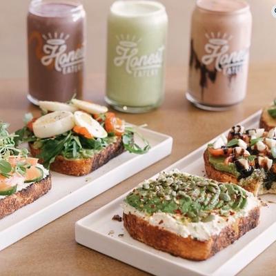 A table displays power toasts on white plates, Three colorful drinks are in background.