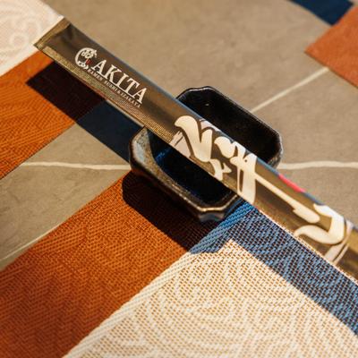 Set of branded chopsticks in a ceramic holder.