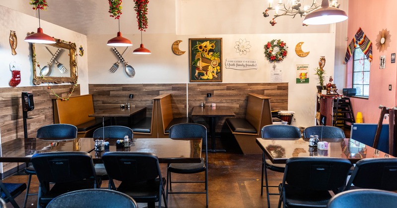 Interior with festive lights, wall art, and booth seating.