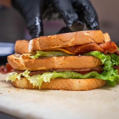Club sandwich being prepared on the kitchen counter, close-up.
