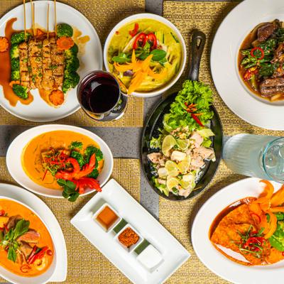 Variety of menu items served on the table with drinks, overhead view.