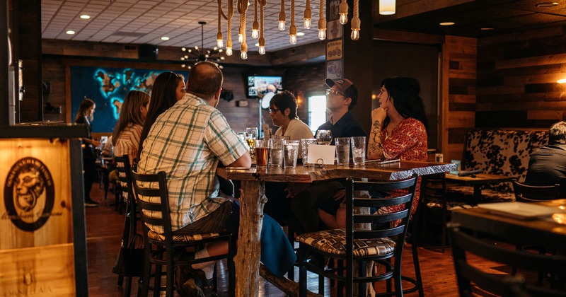 Interior, guests enjoying drinks at table