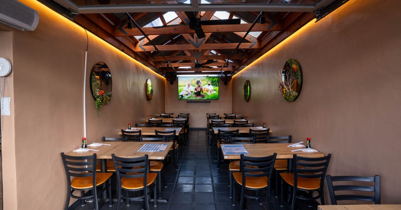 Interior, dining area with big TV on the wall