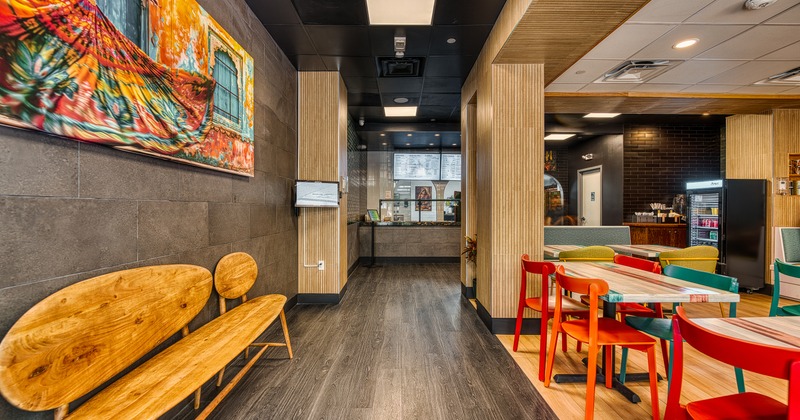 A modern restaurant interior, dining area and order counter