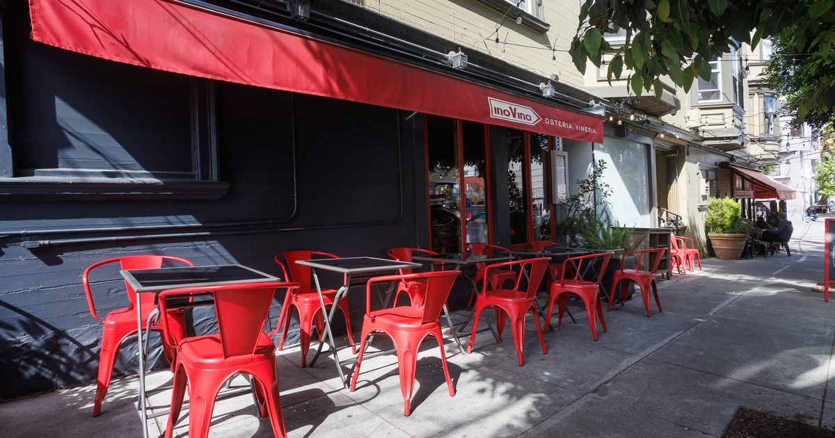 Exterior, side walk patio,in front entrance, tables, chairs,  parasol