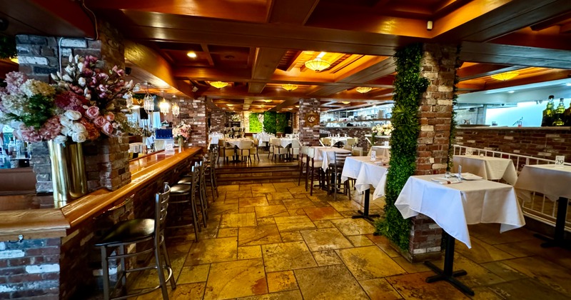 Interior, a floral arrangement on a bar counter, dining table area