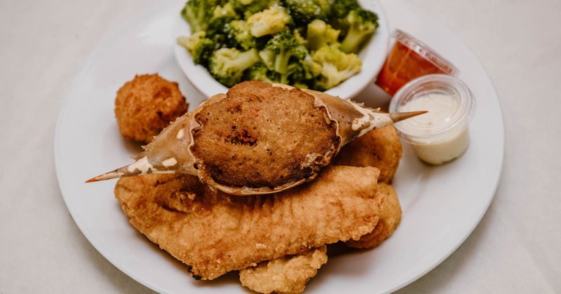 Fried fish platter with broccoli and dipping sauces